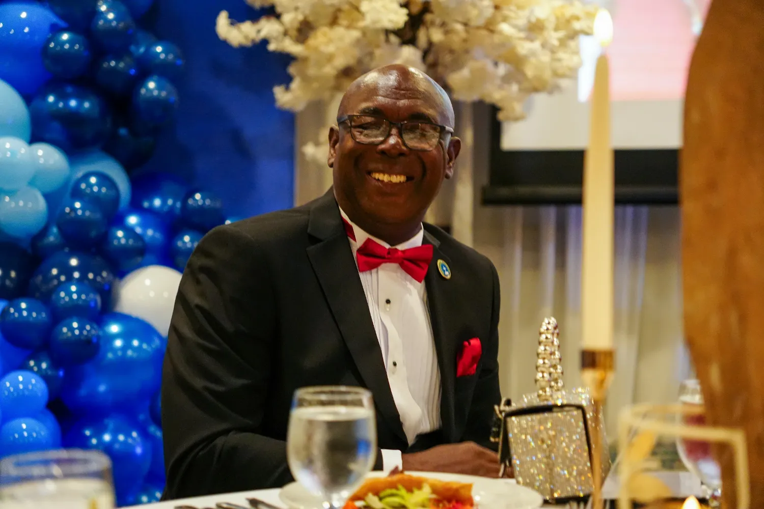 Bishop Donald McFarlane smiles at his table during the celebration of his 40 years of pastoral ministry.