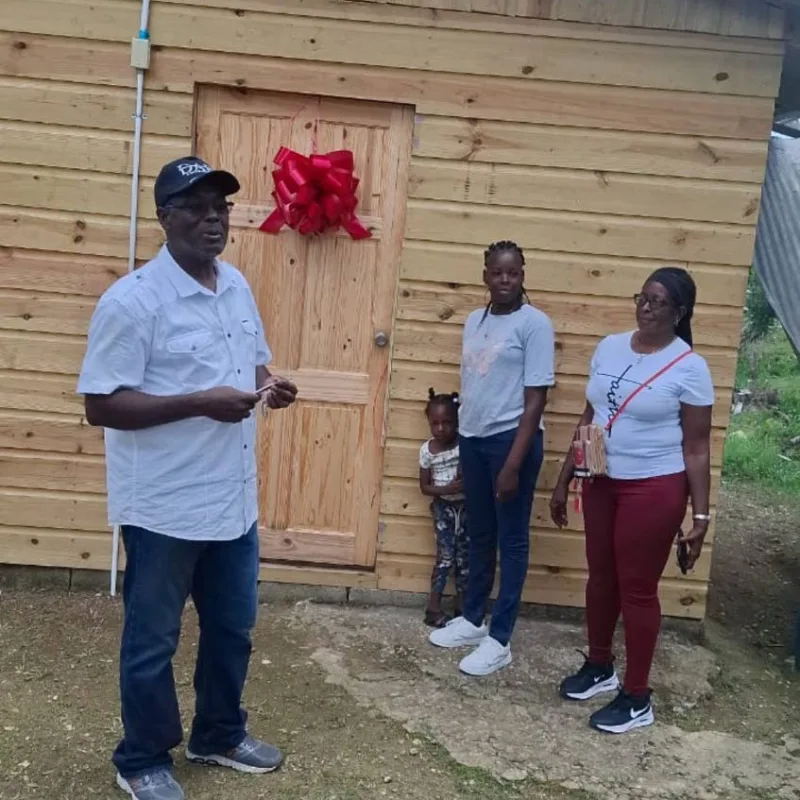 Bishop Donald McFarlane at the handover of a new house to a family in Cornwall Mountain, Westmoreland.
