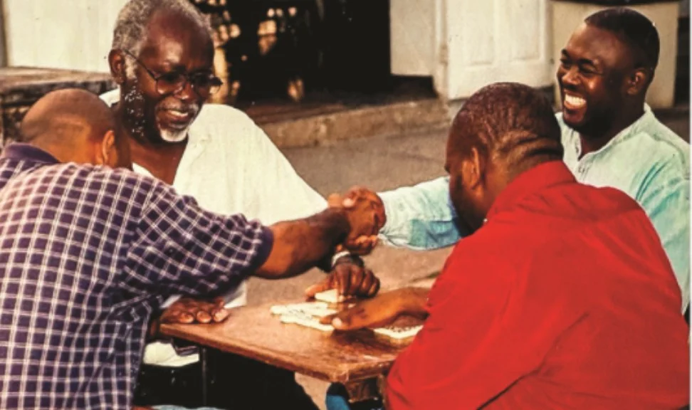 Men of the church playing dominoes at a fellowship table