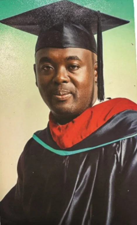 Bishop McFarlane in graduation cap and gown
