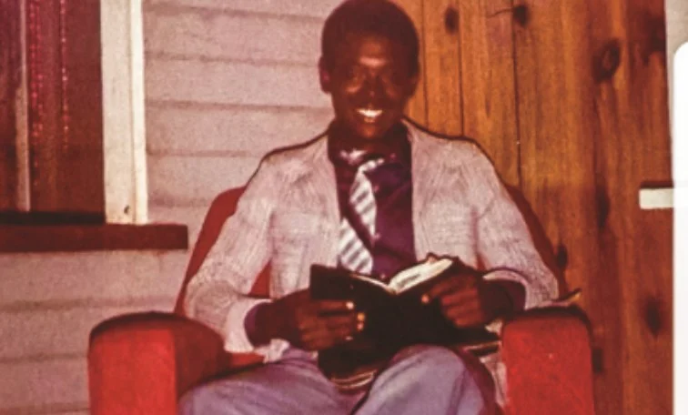 A young Donald McFarlane reading his Bible