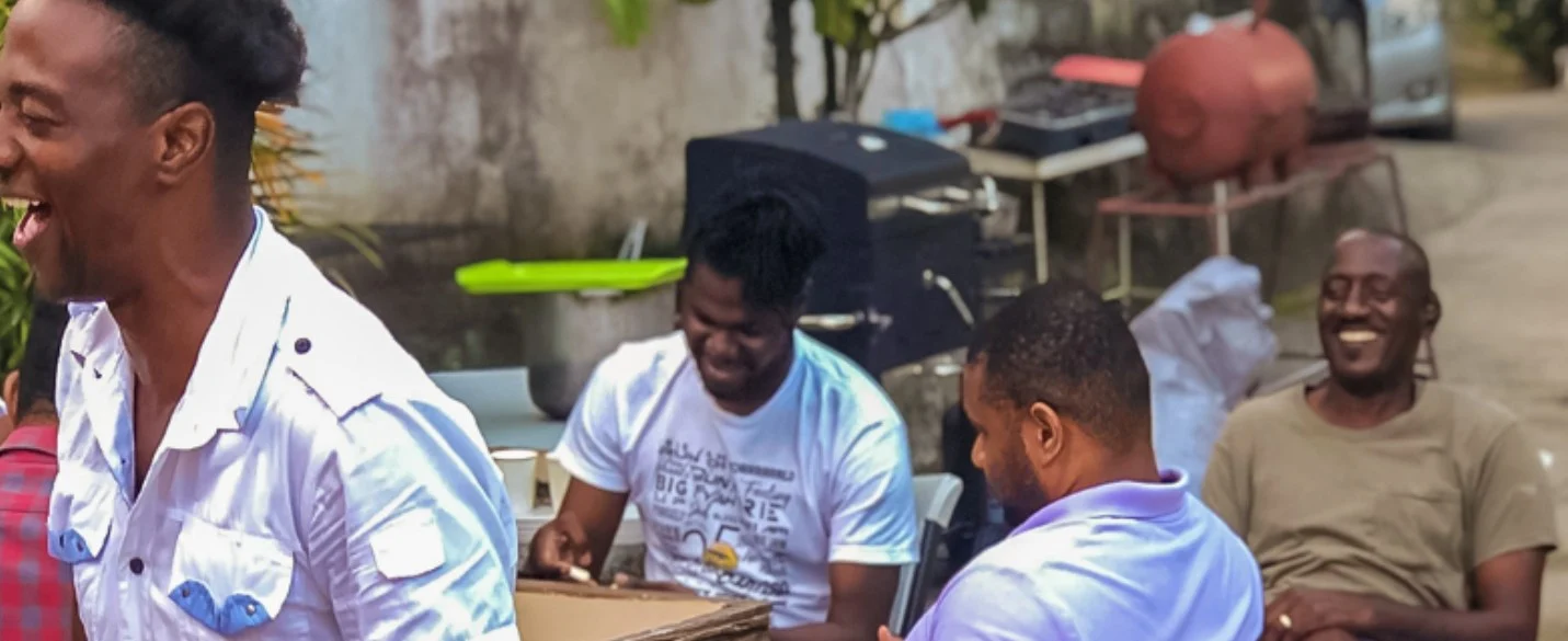 Men of NFCM laughing together at an outdoor gathering