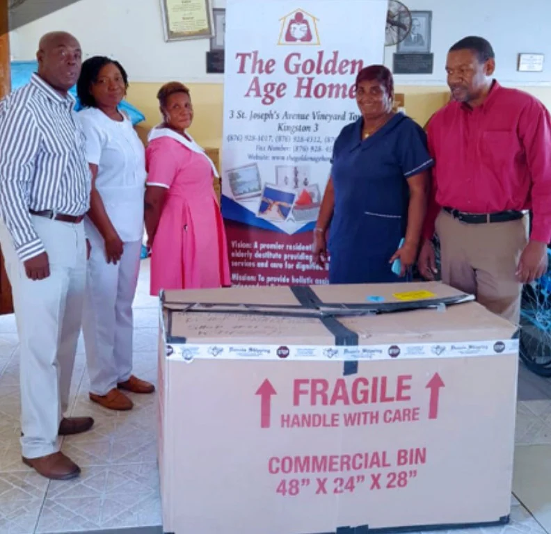 NFCM members with Golden Age Home staff beside a donated commercial bin