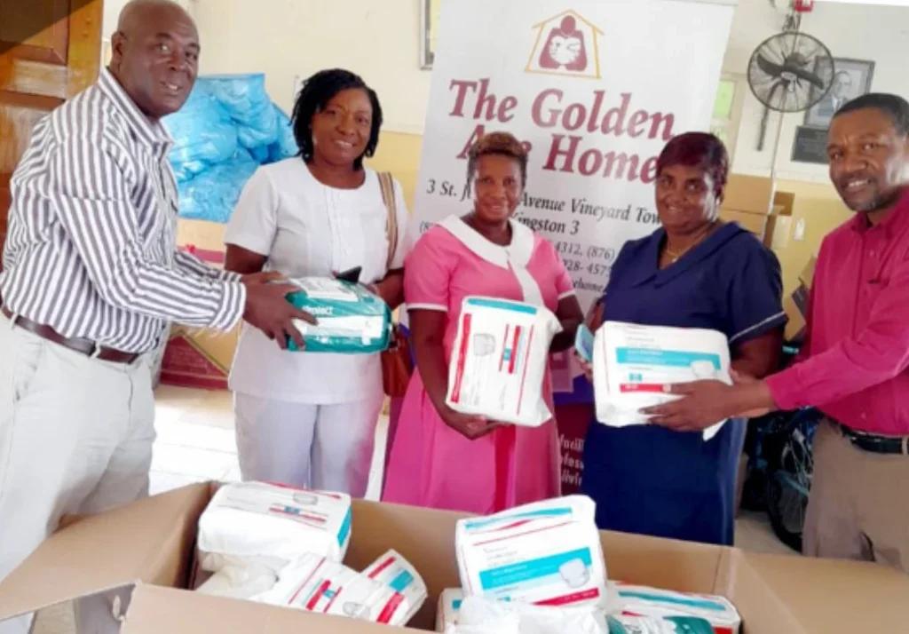 NFCM members handing donated supplies to Golden Age Home staff