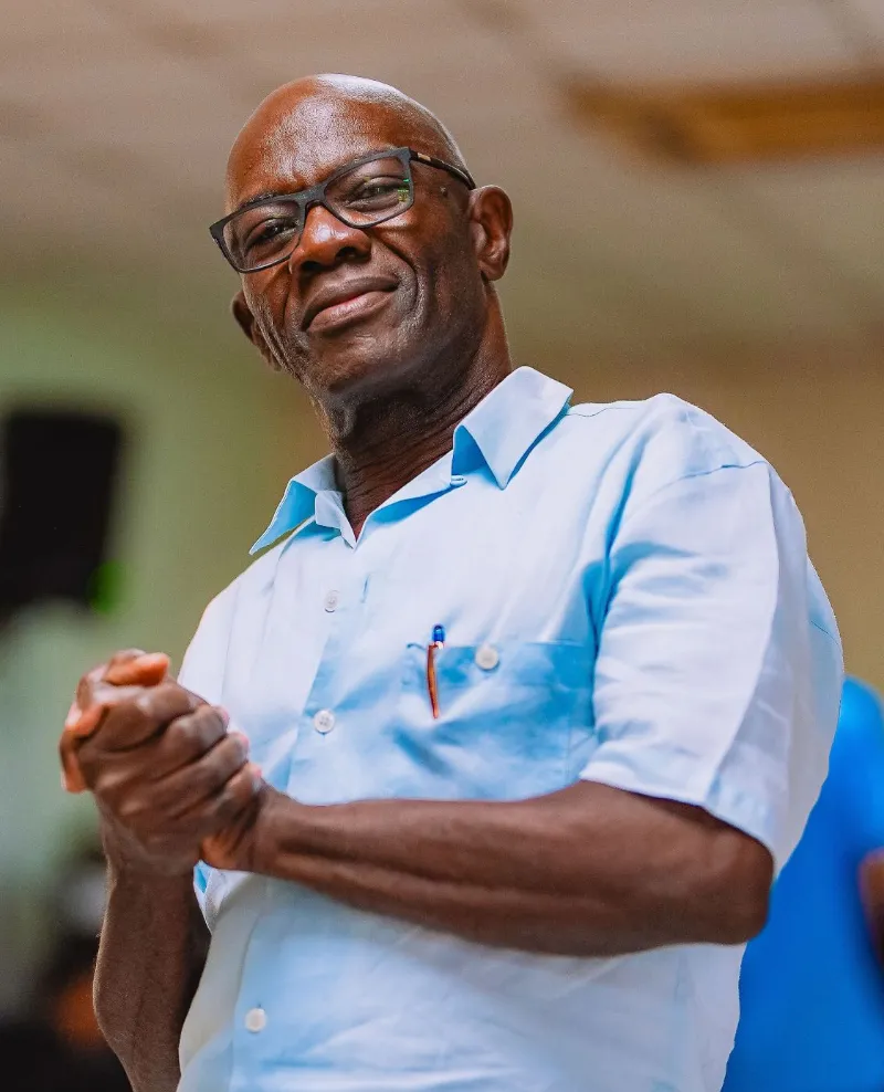 A smiling man in a light blue shirt at the NFCM Prayer Breakfast 2026.