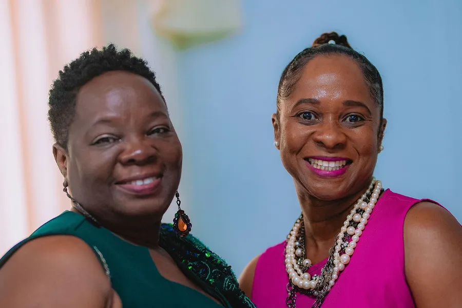 Two women of NFCM smile together at the NFCM Prayer Breakfast 2026.